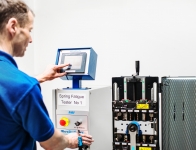 Industry Photography - Operating the machine to test the spring tensions - click to enlarge Industry Photography - Operating the machine to test the spring tensions