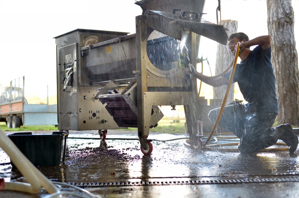 Industry Photography - Washing down the Grape Crusher after use at Brightwell Vineyard Oxford Industry Photography - Washing down the Grape Crusher after use at Brightwell Vineyard Oxford
